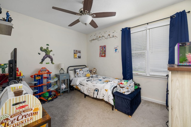 carpeted bedroom featuring a ceiling fan and baseboards