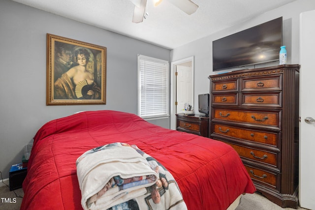 bedroom with a textured ceiling and a ceiling fan