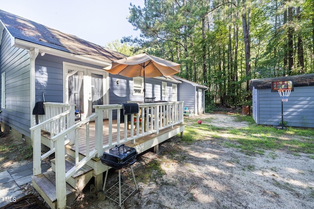 exterior space featuring an outbuilding, driveway, grilling area, and a shed