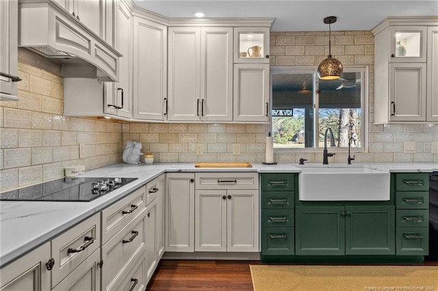 kitchen with a sink, glass insert cabinets, and white cabinets