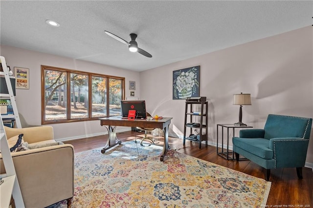 office space with a textured ceiling, recessed lighting, dark wood-style flooring, a ceiling fan, and baseboards