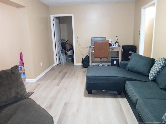 living room featuring baseboards and light wood-style floors