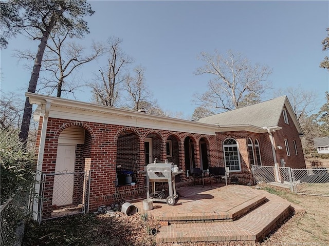 back of house with a patio area, brick siding, and fence