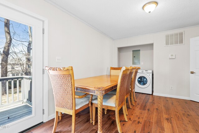 dining space with washer / clothes dryer, wood finished floors, visible vents, and a healthy amount of sunlight