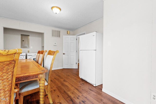 dining area featuring washer / clothes dryer, visible vents, wood finished floors, electric panel, and baseboards