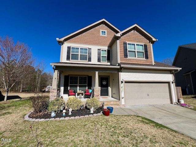 craftsman-style home with a porch, an attached garage, a front lawn, and concrete driveway