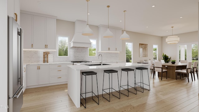 203 E Winmore Ave, Chapel Hill, NC 27516 - kitchen featuring a sink, high end fridge, premium range hood, plenty of natural light, and recessed lighting