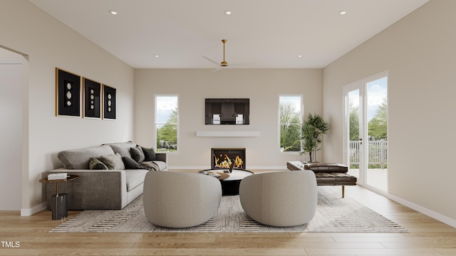 203 E Winmore Ave, Chapel Hill, NC 27516 - living room featuring wood finished floors, healthy amount of natural light, a glass covered fireplace, and recessed lighting