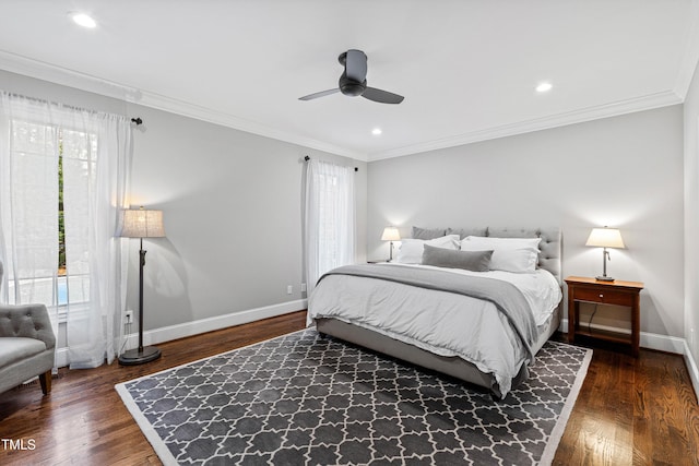 bedroom with crown molding, wood finished floors, and baseboards