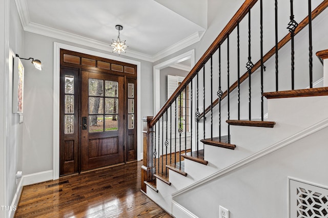 foyer entrance with visible vents, baseboards, stairway, ornamental molding, and wood-type flooring