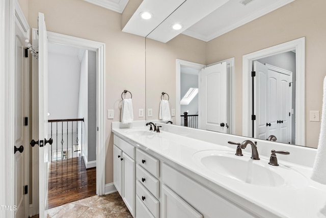 full bathroom featuring double vanity, tile patterned flooring, crown molding, and a sink