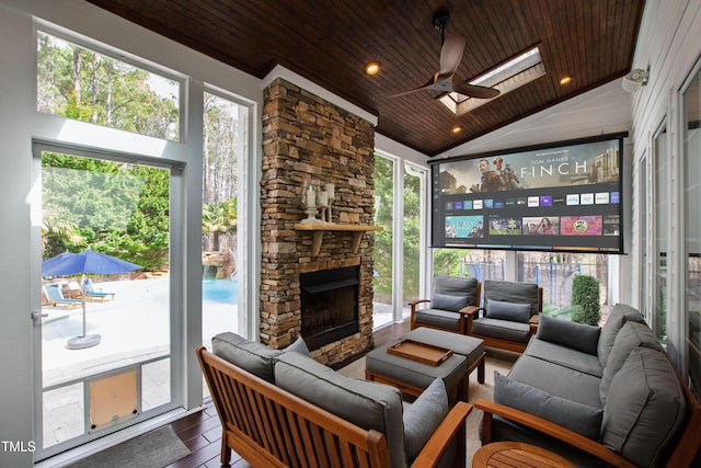 living area featuring dark wood finished floors, wood ceiling, recessed lighting, vaulted ceiling with skylight, and a fireplace