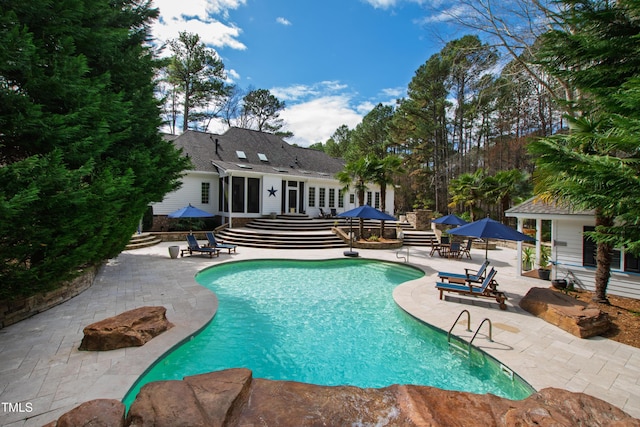 outdoor pool featuring french doors, a patio, and entry steps