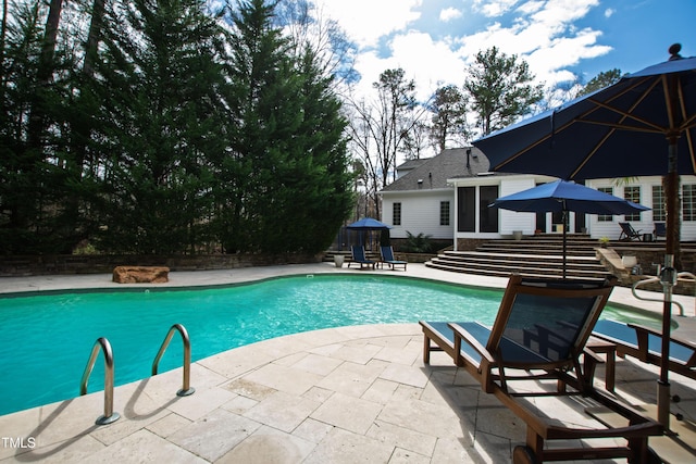 outdoor pool with a patio area