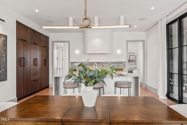 dining space with recessed lighting and light wood finished floors