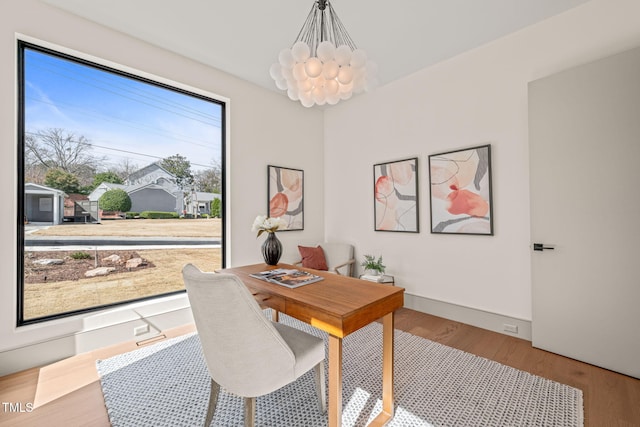 office with a notable chandelier, baseboards, and wood finished floors