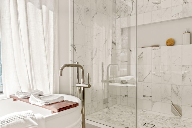 full bath featuring a marble finish shower