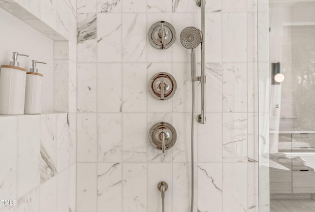 full bathroom with tiled shower