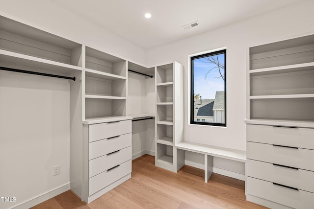 walk in closet featuring light wood-type flooring and visible vents