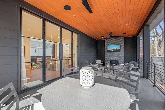 view of patio with a balcony, ceiling fan, and an outdoor hangout area