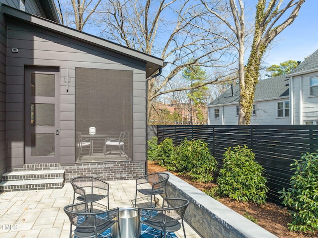 view of patio featuring fence