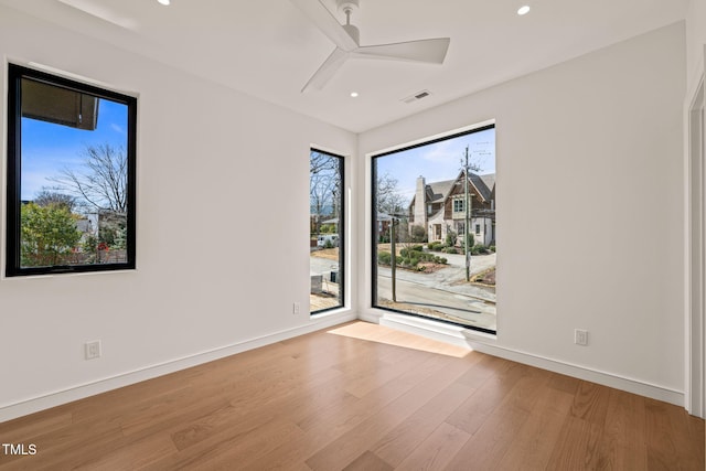 unfurnished room featuring recessed lighting, visible vents, a ceiling fan, wood finished floors, and baseboards