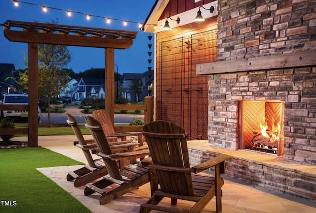 view of patio / terrace featuring a residential view, an outdoor stone fireplace, and a pergola