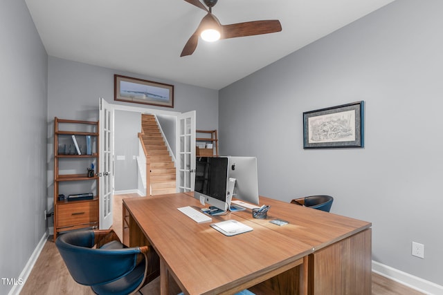 office space with ceiling fan, light wood-type flooring, and baseboards