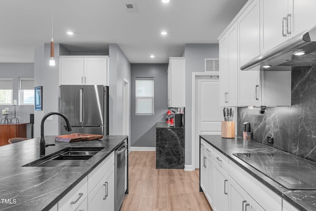 kitchen featuring stainless steel appliances, visible vents, a sink, and under cabinet range hood