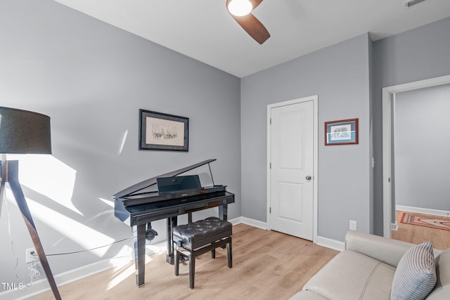 sitting room with ceiling fan, light wood-type flooring, visible vents, and baseboards