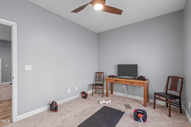 exercise room with a ceiling fan, carpet flooring, and baseboards