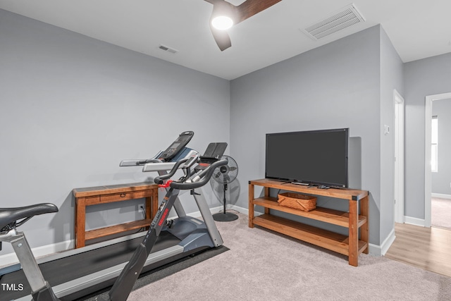 exercise room featuring carpet, visible vents, and baseboards