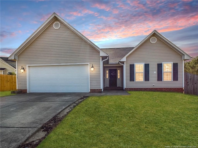 single story home with a garage, fence, a lawn, and concrete driveway