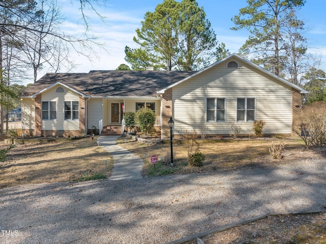 ranch-style home with brick siding and a chimney