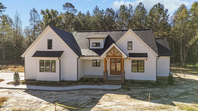 modern farmhouse style home featuring french doors and a shingled roof