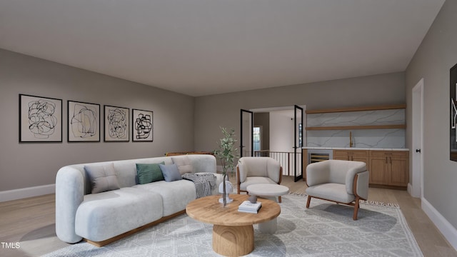 living area with light wood-type flooring and baseboards