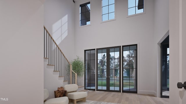 interior space with stairway, wood finished floors, and baseboards