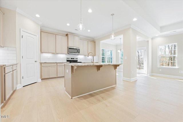 kitchen with light stone counters, stainless steel appliances, light wood-style floors, a kitchen breakfast bar, and decorative backsplash