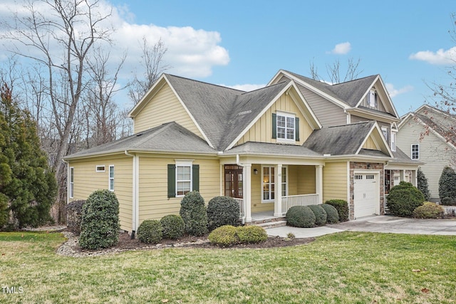 view of front of property featuring covered porch, concrete driveway, board and batten siding, a front yard, and a garage