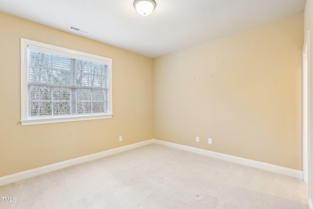 unfurnished room featuring light carpet, baseboards, and visible vents