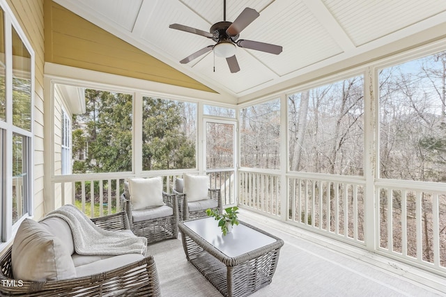 sunroom featuring a healthy amount of sunlight, vaulted ceiling, and ceiling fan