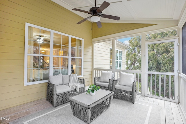 sunroom / solarium featuring ceiling fan and vaulted ceiling