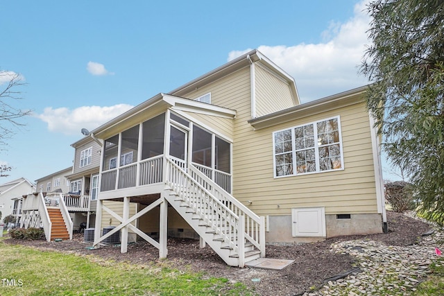 back of property featuring a sunroom, stairway, and crawl space