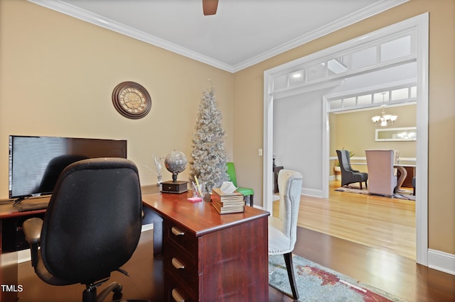 office area with ceiling fan with notable chandelier, baseboards, crown molding, and wood finished floors