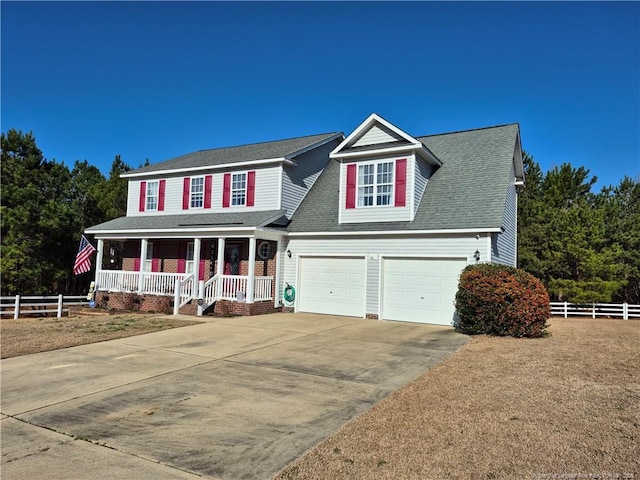 view of front of home featuring a garage, fence, a porch, and concrete driveway