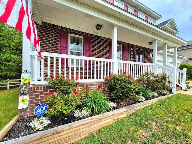 11 Scotland Dr, Spring Lake, NC 28390 - doorway to property featuring a porch and brick siding