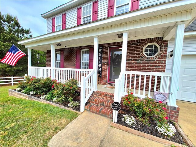11 Scotland Dr, Spring Lake, NC 28390 - view of exterior entry featuring brick siding, a porch, and fence