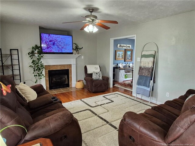 11 Scotland Dr, Spring Lake, NC 28390 - living room featuring a tiled fireplace, ceiling fan, and wood finished floors
