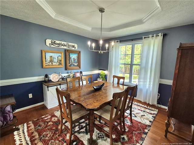 11 Scotland Dr, Spring Lake, NC 28390 - dining room featuring baseboards, ornamental molding, a chandelier, a tray ceiling, and wood finished floors