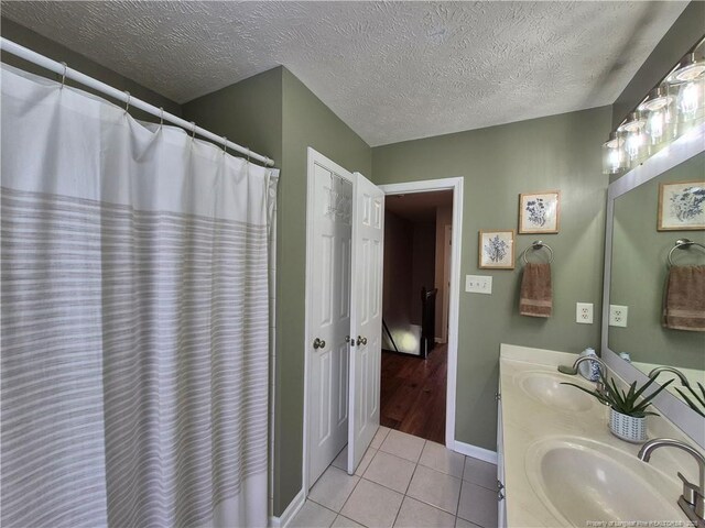 11 Scotland Dr, Spring Lake, NC 28390 - full bathroom featuring tile patterned floors, double vanity, a textured ceiling, and a sink